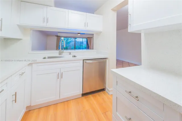 a kitchen with stainless steel appliances granite countertop a sink and a stove