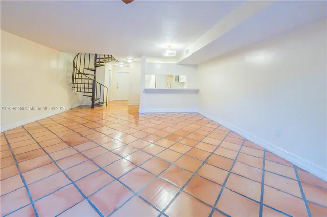 a view of an empty room and wooden floor