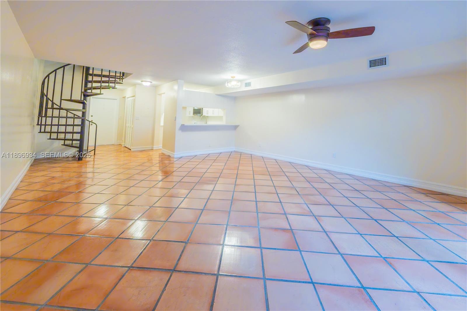 7890 Southwest 86th Street, Unit 11 Miami, FL 33156 - Photo 9 of 31 a view of an empty room and wooden floor