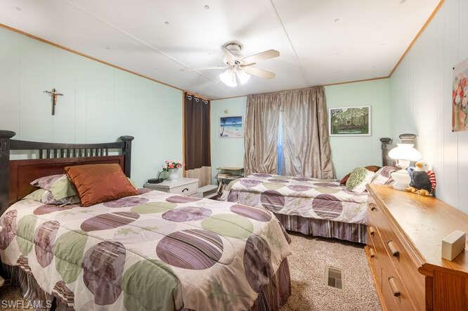 131 Grassy Key Lane, Unit 44 Naples, FL 34114 - Photo 24 of 30 Bedroom with carpet flooring, ceiling fan, and crown molding