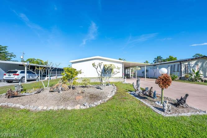 131 Grassy Key Lane, Unit 44 Naples, FL 34114 - Photo 7 of 30 Manufactured / mobile home with a carport and a front yard