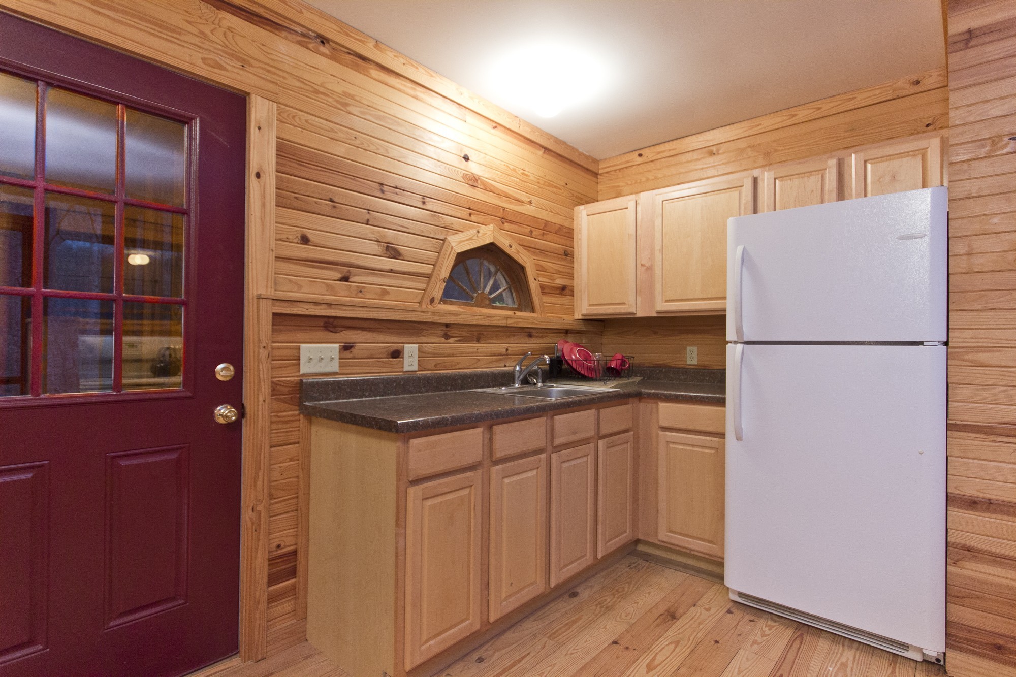 399 Coaling Road Charlotte, TN 37036 - Photo 16 of 32 a kitchen with granite countertop a sink and a refrigerator