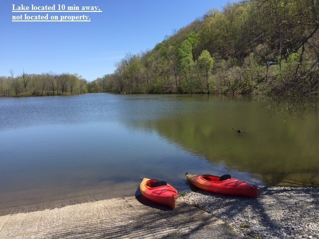 399 Coaling Road Charlotte, TN 37036 - Photo 32 of 32 a view of a lake with an outdoor space
