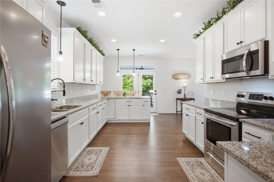 525 16th Circle Walhalla, SC 29691 - Photo 48 of 50 This bright kitchen features wood flooring and white cabinetry, ready for culinary creations.