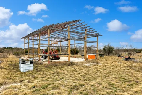 a view of a swimming pool with an outdoor seating and a pathway
