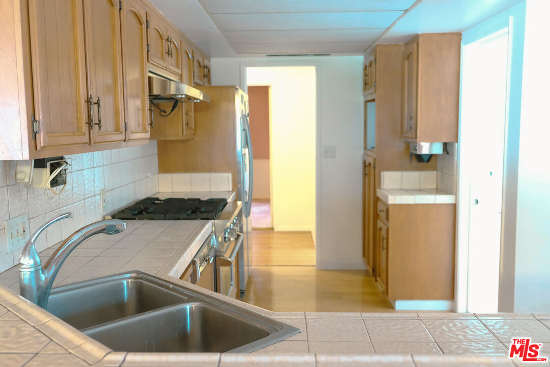 Undisclosed Address Los Angeles, CA 90066 - Photo 7 of 27 a kitchen with a sink and a refrigerator