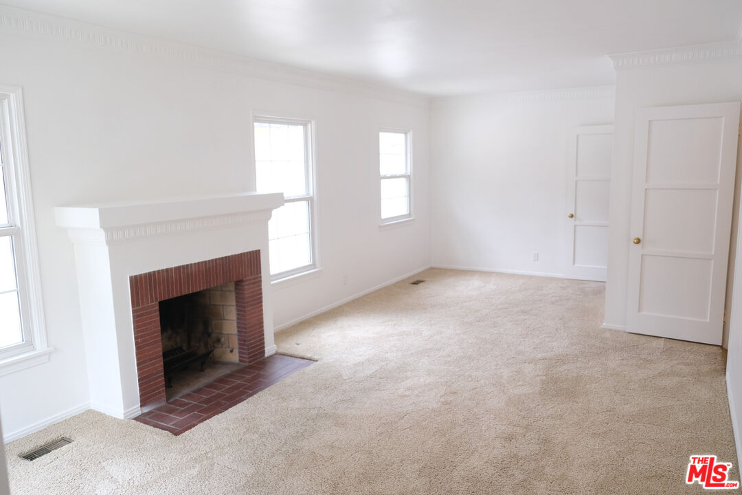 Undisclosed Address Los Angeles, CA 90066 - Photo 10 of 27 an empty room with windows and fireplace