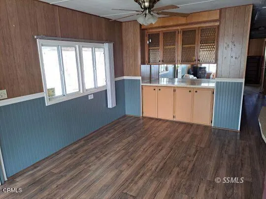 a room with wooden floors and white walls