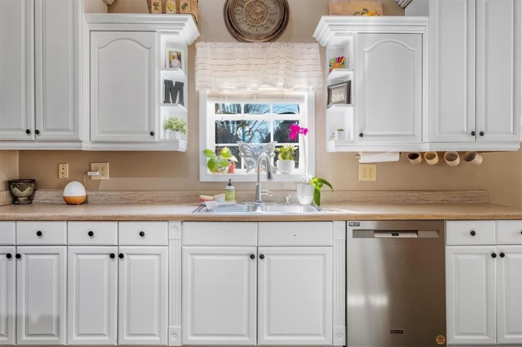37 Heather Circle Cave Spring, GA 30124 - Photo 12 of 32 a kitchen with white cabinets and clock on the wall