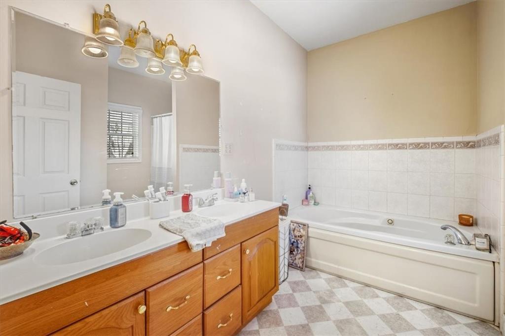 37 Heather Circle Cave Spring, GA 30124 - Photo 19 of 32 a bathroom with a tub sink and mirror