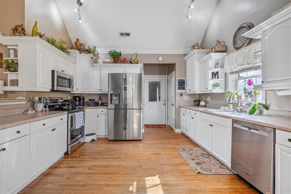 37 Heather Circle Cave Spring, GA 30124 - Photo 10 of 32 a kitchen with refrigerator cabinets and wooden floor