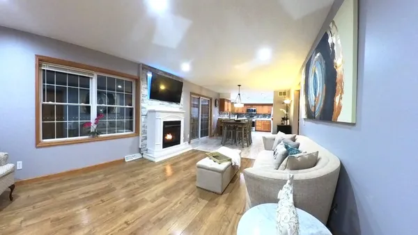 a view of a livingroom with furniture and a flat screen tv
