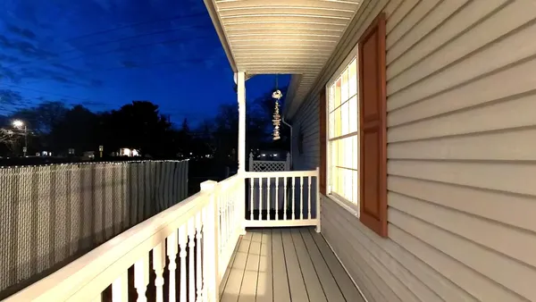 a view of balcony with wooden floor