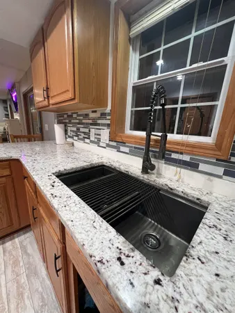 a kitchen with stainless steel appliances wooden cabinets a sink and a stove