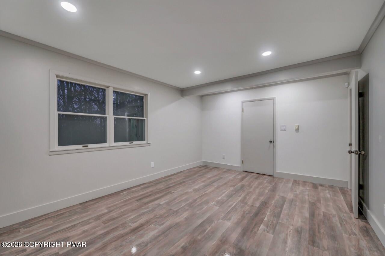384 Devils Hole Road Cresco, PA 18326 - Photo 67 of 97 a view of empty room with wooden floor and fan