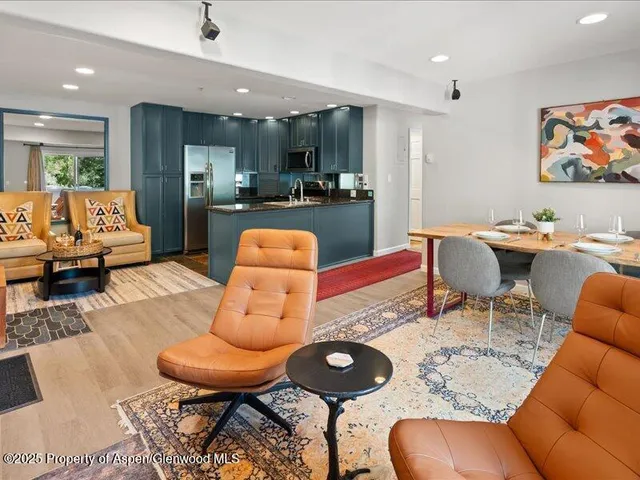 a living room with furniture and kitchen view