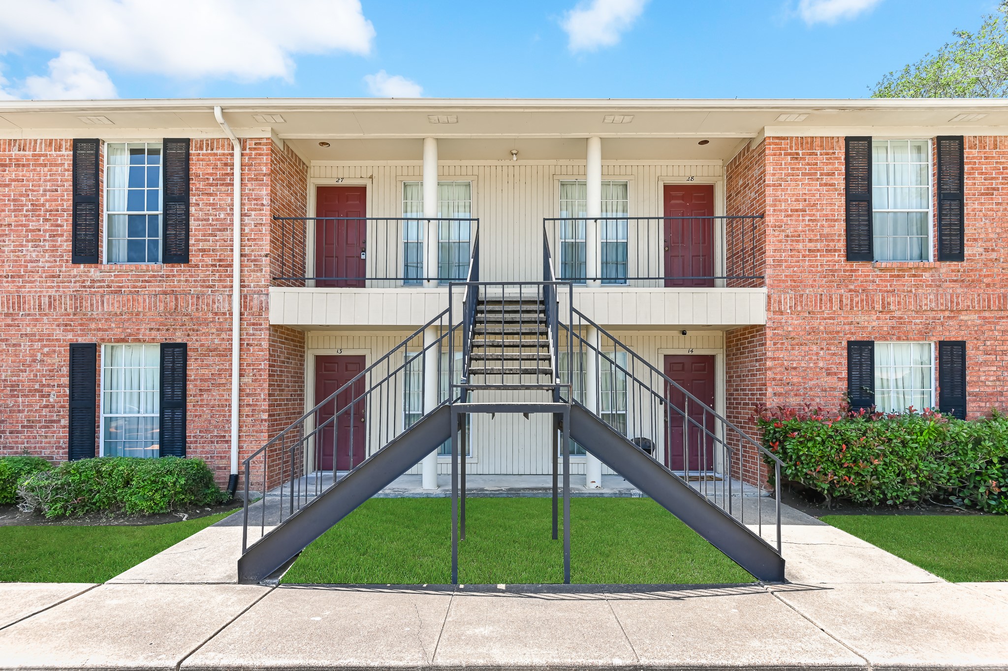a view of a brick house with a yard