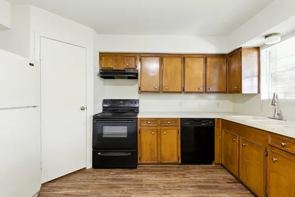 a kitchen with stainless steel appliances granite countertop a stove and a refrigerator