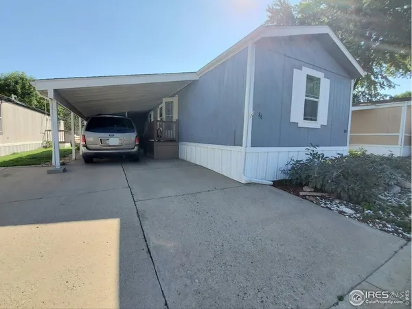 a couple of cars parked in front of a house