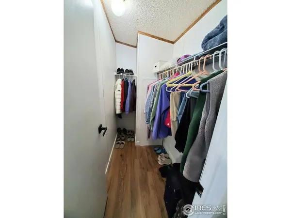 a view of walk in closet with clothes