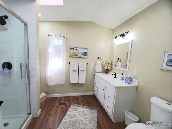 a bathroom with a double vanity sink toilet and shower
