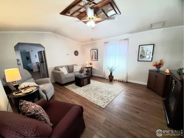 a living room with furniture and wooden floor