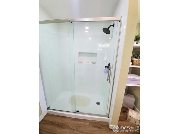 a bathroom with a glass shower door