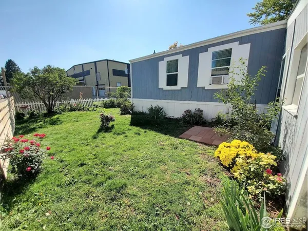 a backyard of a house with a yard and outdoor seating