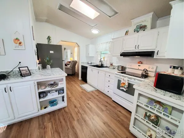 a kitchen with stainless steel appliances a stove a sink dishwasher and a refrigerator