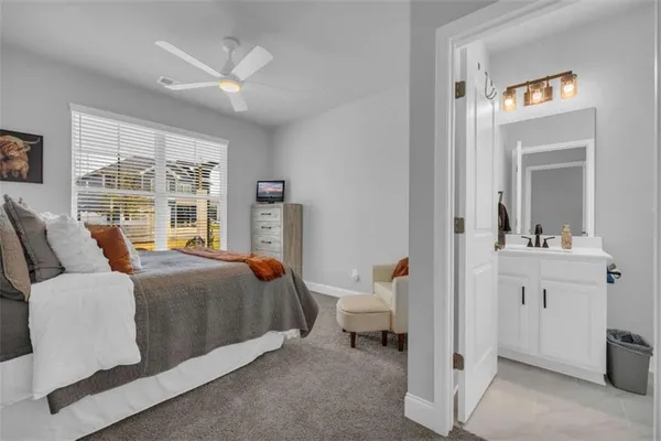 a living room with furniture ceiling fan and a rug