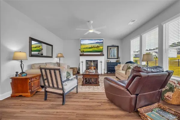 a kitchen with stainless steel appliances a white table chairs and a refrigerator