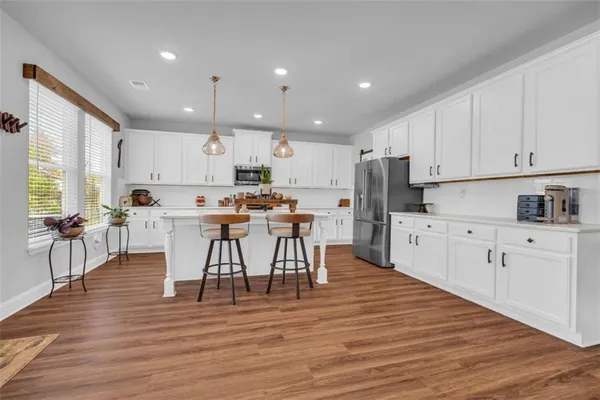 a kitchen with white cabinets and white appliances