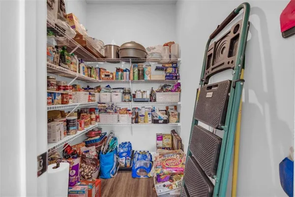 a bedroom with a bed a couch and a window