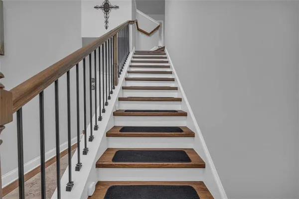 a bedroom with a bed and a flat tv screen on the dresser