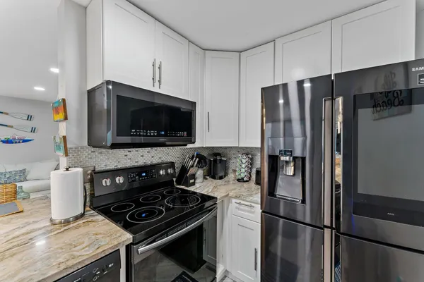 a kitchen with stainless steel appliances a refrigerator stove and microwave