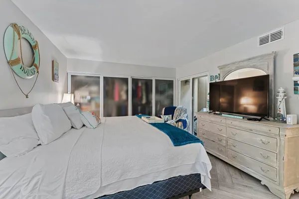 a bedroom with a bed and a flat screen tv