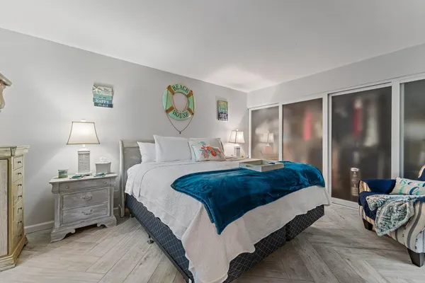 a bedroom with a bed and a lamp