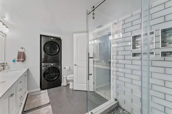 a bathroom with a sink a toilet and shower