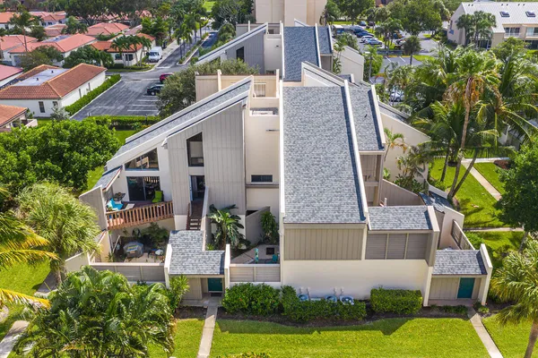 an aerial view of a house with a yard and potted plants