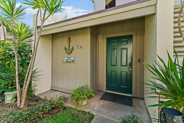 a front view of a house with a plants