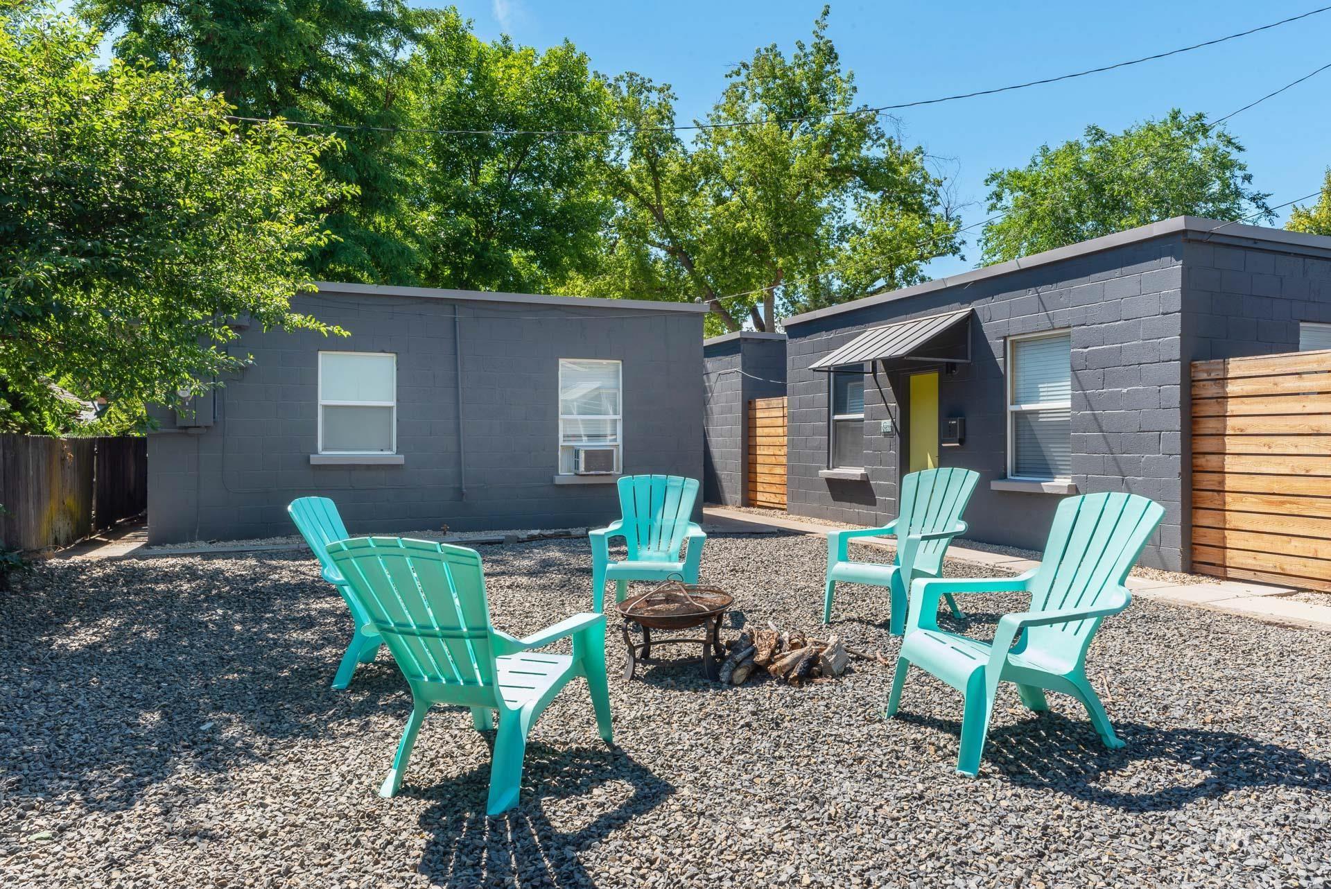 Back of property featuring concrete block siding, a fire pit, and a patio area