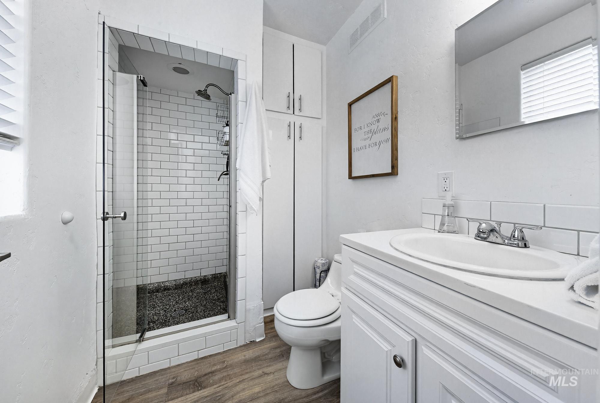 2104 North 18th Street Boise, ID 83702 - Photo 12 of 19 Full bath with vanity, a stall shower, and dark wood-type flooring