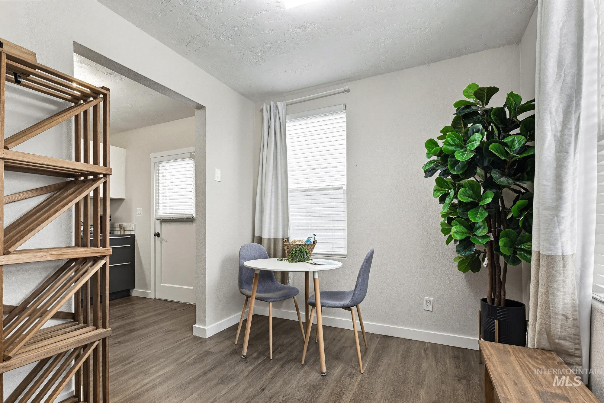 2104 North 18th Street Boise, ID 83702 - Photo 7 of 19 Dining area with dark wood-type flooring and a textured ceiling