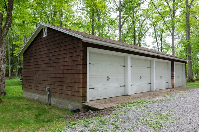 a view of a backyard with wooden fence and a bench
