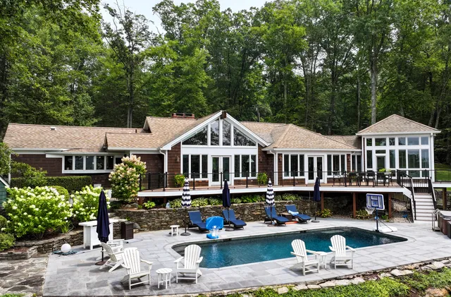 a front view of a house with yard and fountain