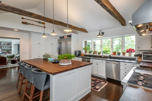 a kitchen with stainless steel appliances granite countertop a stove a sink and a refrigerator