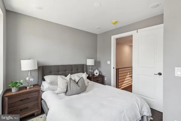 a bedroom with a bed and a lamp