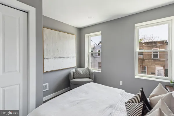 a bedroom with furniture and a window