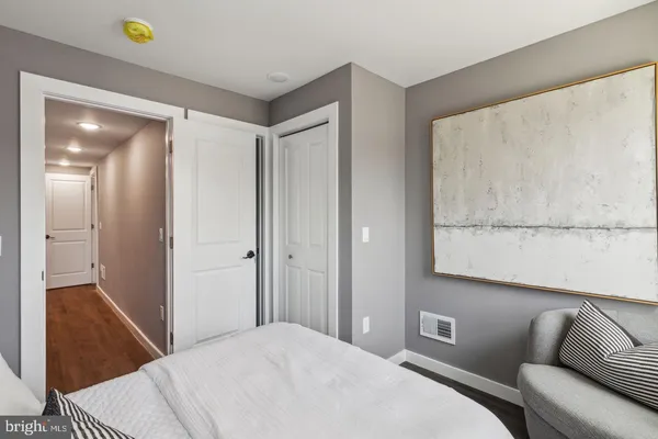 a bedroom with a bed and a couch