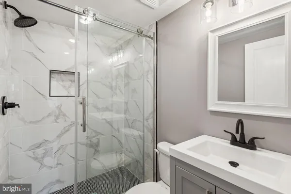 a bathroom with a sink toilet and shower